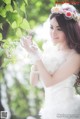 A woman in a wedding dress holding a bouquet of flowers.