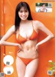 A woman in an orange bikini posing for a magazine cover.