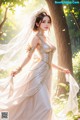 A woman in a wedding dress standing in the woods.